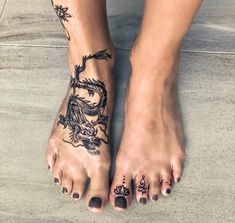 a woman's feet with tattoos on them