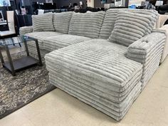 a large sectional couch sitting on top of a carpeted floor