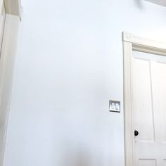 an open door in a room with white walls