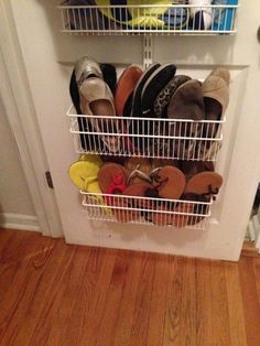 an image of a closet with shoes and other items in it on the bottom shelf