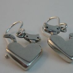 Cute Silver Sterling Heart Earrings, Cute Silver Heart Earrings In Sterling Silver, Cute Double Heart Silver Earrings, Silver Double Heart Cute Earrings, Sterling Silver Heart Earrings With Lever Back, Cute Sterling Silver Heart Charm Earrings, Silver Heart-shaped Cat Design Jewelry, Cute Sterling Silver Heart Earrings With Charm, Cute Sterling Silver Heart Earrings