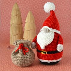 a crocheted santa clause is next to a small bag