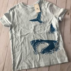 This Adorable 100% Cotton Boys Shark Size 2t Cute Gap Crew Neck Top, Cute Gap Cotton T-shirt, White Cotton Gap Top, Gap Cotton Tops For Playtime, Gap White Graphic Print T-shirt, White Gap T-shirt With Graphic Print, Playful Cotton Tops By Gap, Gap Graphic Tee For Spring, Playful Gap Tops For Playtime