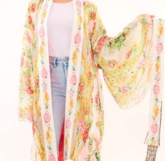 Floral print kimono with birth of Venus print on the back, floral print lace flare sleeves, floral print fringed belt, side slits & contrast lining Pearl print Hand wash cold with like colors Line dry Shell: 100% viscose, sleeves: 100% cotton & lining: 100% polyester 8.28.23KH Spring Floral Print Fitted Kimono, Fitted Floral Print Kimono For Spring, Spring Fitted Wrap Kimono, Fitted Wrap Kimono For Spring, Elegant Spring Cotton Kimono, Fitted Floral Print Kimono, Spring Daywear Wrap Kimono, Spring Wrap Kimono For Daywear, Fitted Floral Kimono For Festival