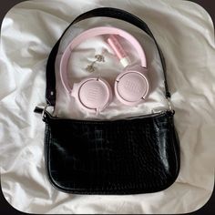 a purse with headphones on top of it