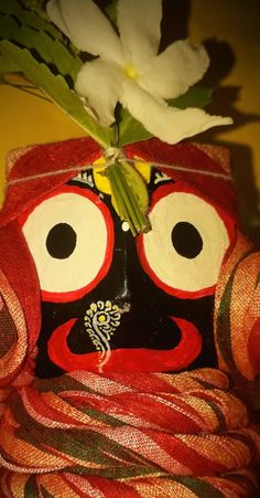 a close up of a mask with flowers in it