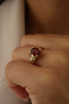 Featuring a beautiful oval center stone made of garnet set in a grooved-like setting. Please allow 1-2 weeks for delivery. Garnet Engagement Ring Gold, Engagement Ring Gold, Garnet Engagement Ring, Pre Black Friday, Pave Band, New Bands, Gold Engagement Rings, Ring Collections, Ring Ring