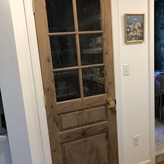 a wooden door with glass on the front and side panels is shown in this entry way