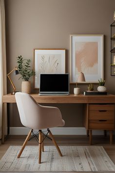 a laptop computer sitting on top of a wooden desk next to a plant and lamp