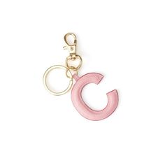 a pink keychain with the letter c on it's front and bottom