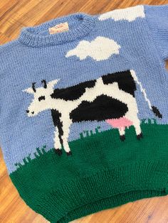 a sweater with a cow painted on it