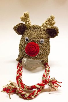 a crocheted reindeer hat with red nose and antlers attached to the top