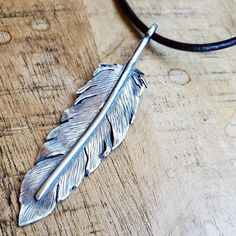 This hand-fabricated Feather Pendant Necklace is made with sterling silver. It has been given lots of details to give an artsy semi-realistic look to the piece and a dark patina to resl highlight the details. The feather is 3" long and made of 20 gauge sterling silver sheet and half round sterling wire. You can choose to have the top finding as a closed loop or created as a shepherd's hook so that you can hook it into your other necklaces or change it up to your various favourite chains or cords Feather Pendant Necklace, Semi Realistic, Feather Necklace, Bird Necklace, Feather Pendant, Silver Feather, Summer Earring, Turquoise Cuff, Feather Necklaces