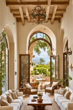 a living room filled with furniture and an arched doorway leading to a patio area covered in greenery