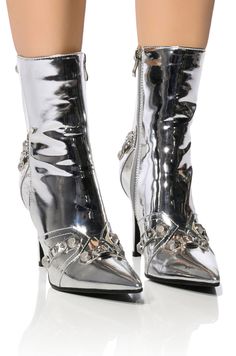 Strut through every borough in The AZALEA WANG Brooklyn Metallic Stiletto Bootie In Silver. This metallic faux leather ankle bootie features a pointed toe silhouette, a slim stiletto heel, and an ankle height shaft. Complete with faux buckle accents throughout, silver metallic hardware, top zip detailing, tassel trim, and a classic inner ankle zipper closure. Style with your favorite high waisted denim, the matching AKIRA Label Tweety Silver Futuristic Purse, and a rocker chic moto jacket. (Fit and details approximate size 8): - Pointed toe - Stiletto heel - 7” shaft height - 3.75” heel height - Imported Product ID: 317161 Silver High Heel, Silver High Heels, Azalea Wang, Dope Makeup, Rocker Chic, Ankle Bootie, High Heel Boots, High Waisted Denim, Stiletto Heel