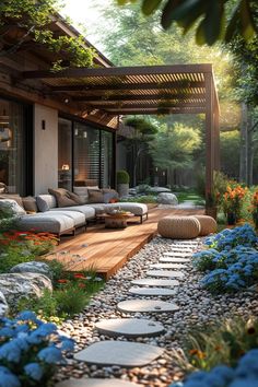 an outdoor living area with flowers and rocks