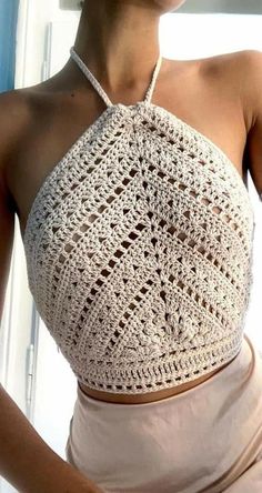 a woman wearing a crochet halter top