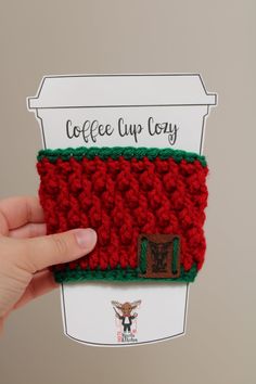 someone is holding up a coffee cup cozy