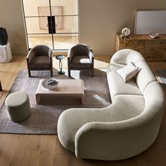 a living room filled with furniture on top of a hard wood floor