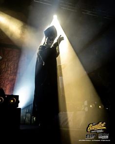 a man standing in front of a stage light