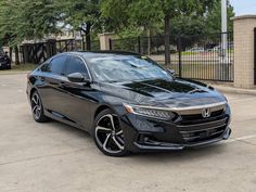 a black honda accord is parked in a parking lot