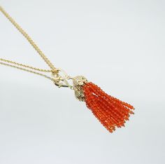 ⚜ Orange Zirconia Tassel Necklace  ❀ Handmade Orange Zirconia Tassel ❀ Gold Plated Brass Lotus Detachable Connector ❀ Length 24 in. (61cm)   The Orange Zirconia Tassel Necklace features a sparkly lotus detachable tassel connector and a handmade zirconia tassel, blending elegance with modern sophistication. The lotus symbolizes purity and spiritual growth, making this versatile piece a meaningful and graceful addition to any jewelry collection. Asian Jewelry, The Oscars, The Lotus, Spiritual Meaning, Golden Globes, Necklace Handmade, Unique Necklaces, Spiritual Growth, Handmade Necklaces