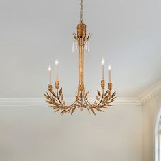 a chandelier hanging from the ceiling in a room with white walls and windows