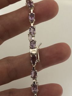 Vintage Purple Amethyst Bracelet 925 Sterling Silver Tennis This amethyst bracelet is very lively and bright. The stones are deep colors and well matched. The sterling silver is plated with rhodium to protect the bracelet from tarnish and give the appearance of white gold. 7.5 in My jeweler can shorten it for a $20 fee. All jewelry is shipped free in the US in a nice gift box. Check out our over a THOUSAND great reviews Engraving is $4 per letter and is not always perfect depending on the piece. Luxury Vintage Purple Bracelets, Purple Luxury Tennis Bracelet, Luxury Purple Sterling Silver Bracelets, Formal Amethyst Gemstone Sterling Silver Bracelet, Amethyst Gemstone Tennis Bracelet Gift, Amethyst Gemstone Tennis Bracelet, Elegant Sterling Silver Amethyst Gemstone Bracelet, Silver Amethyst Tennis Bracelet With Gemstones, Marcasite Bracelet