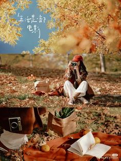 a woman sitting on the ground with her cell phone to her ear, surrounded by autumn leaves