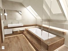 a bathroom with a large bathtub and wooden floors in the middle of the room