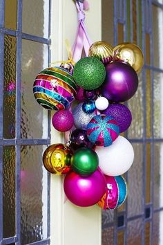 a bunch of ornaments hanging from the side of a door