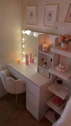 a bedroom with a vanity, desk and chair next to a window filled with candles