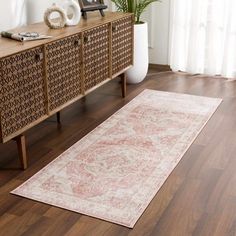 an area rug is on the floor next to a dresser