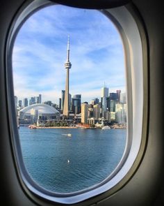 an airplane window looking out at the city