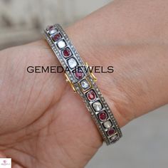 Polki Diamond Silver Bangle, Red Ruby Gemstone Bangle, 925 Sterling Silver Jewelry, Openable Bangle Bracelet, Wedding Gift, Gift For her Gross Weight: 29.59 gram Gemstone Weight: 8.91 cts Polki Diamond Weight: 1.52 cts Pave Diamond Weight: 2.44 cts Bangle Size: 63X63 MM NOTE:- All The Products Are Designed And Manufactured In My Workshop By Me & My Team. Shown Products Are Purely Handmade. Custom Orders Are Open Handly Accepted. We Are Perfect Choice For Any Custom Jewelry Manufacturing. For Sterling Silver Gemstone Bangle For Anniversary, Fine Jewelry Rose Cut Diamond Bracelet For Anniversary, Fine Jewelry Anniversary Bracelet With Rose Cut Diamonds, Adjustable Red Cuff Bracelet For Wedding, Red Adjustable Cuff Bracelet For Wedding, Red Rose Cut Diamond Jewelry Gift, Gift Red Rose Cut Diamond Jewelry, Diamond Gemstone Bracelets For Anniversary, Oval Gemstone Bangle For Wedding