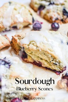 blueberry scones with white icing on a plate