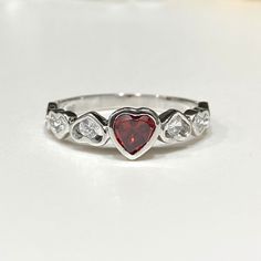 Vintage Sterling Silver Garnet & White Topaz Heart Ring ...Marked 925...Total of weights 2.1grams...Size 9...Measure of Face 6.2MM...It's in very good condition. Heart Engagement Rings Silver, Heart-shaped Topaz Promise Ring, Hallmarked Heart-shaped Diamond Ring, Heart-shaped Sterling Silver Diamond Ring, Valentine's Day Sterling Silver Diamond Ring With Center Stone, Anniversary Heart Cut Topaz Ring In Sterling Silver, Valentine's Day Diamond Heart Ring, Hallmarked, Valentine's Day Diamond Heart Ring Hallmarked, Valentine's Day Hallmarked Diamond Heart Ring