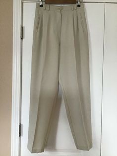 Excellent condition. Worn twice. Washed and ironed. 80% polyester and 20% rayon. Very nice and comfortable. See photos to view and ask me questions as you may have any. Thanks for looking. Cream Wide Leg Dress Pants For Formal Occasions, Classic Straight Leg Cream Dress Pants, Classic Cream Straight Leg Dress Pants, Spring Beige Dress Pants For Formal Occasions, Spring Formal Beige Dress Pants, Classic Beige Dress Pants For Spring, Classic Fitted Cream Dress Pants, Classic Cream Tapered Leg Pants, Formal Cream Bottoms With Pockets