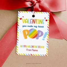 a valentine's day card hanging from a red ribbon