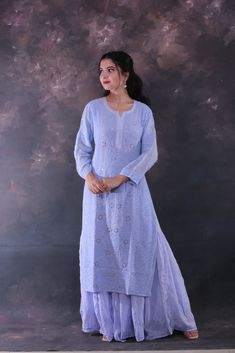 This beautiful hand embroidered chikankari kurit embellished with mukaish work along with heavy flare garara set is a must-have this season. Made from pure georgette fabric and hand embroidered all over, it is sure to make you stand out in the crowd. Kurti length- 44-48 inches. Garara size- Free size can fit upto size 48. Customisation- Dyeable in any colour. Add an order note with the shade number to get the set dyed in any specific colour you want without any extra charges. Bollywood Style Blue Chikankari Embroidered Palazzo Set, Blue Bollywood Palazzo Set With Chikankari Embroidery, Festive Blue Palazzo Set With Chikankari Embroidery, Festive Light Blue Sharara With Chikankari Embroidery, Unstitched Light Blue Sharara With Resham Embroidery, Bollywood Style Light Blue Chikankari Embroidery Sets, Light Blue Chikankari Traditional Wear For Diwali, Bollywood Light Blue Chikankari Embroidery Set, Bollywood Style Light Blue Set With Chikankari Embroidery