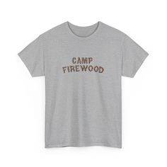 Inspired by the iconic summer camp in the cult classic movie Wet Hot American Summer. This vintage-style t-shirt features the classic Camp Firewood logo on a soft, comfortable fabric that will make you feel like you're ready to hit the bunk beds and relive those summer camp memories. Whether you're a die-hard fan of the movie or just love the retro camp aesthetic, this t-shirt is the perfect addition to your wardrobe. So grab your bug spray and your s'mores, and get ready to channel your inner camp counselor in style with the Camp Firewood t-shirt. .: 100% cotton.: Classic fit.: Tear-away label.: Runs true to size S M L XL 2XL 3XL Width, in 17.99 20.00 21.97 23.98 25.98 27.99 Length, in 28.00 29.00 30.00 31.00 32.00 33.00 Sleeve length (from center back), in 15.75 16.93 18.50 20.08 21.65 2 Cotton T-shirt With Letter Print For Camping, Graphic Tee With Text Print For Camping, Cotton Camp Shirt With Letter Print For Camping, Cotton Camp Shirt With Letter Print For Outdoor, Pre-shrunk Cotton Camp Shirt For Camping, Summer Camping Graphic Tee, Summer Graphic Tee For Camping, Camping Cotton T-shirt With Screen Print, Camping Cotton Screen Print T-shirt