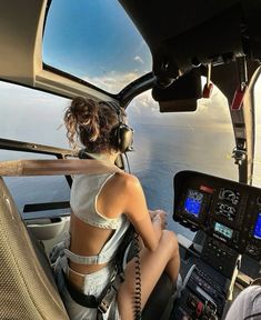 two women are sitting in the cockpit of an airplane and looking out at the water