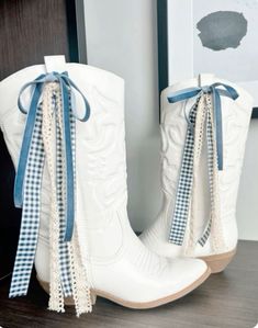 Fall Outfit White Cowboy Boots, Ribbon On Cowgirl Boots, Game Day Boots Ribbon, Country Concert White Boots, Ribbon On Cowboy Boot, Ribbon Cowboy Boots, Ribbons On Cowboy Boots, Cowgirl Boots With Ribbon, Bows On Cowboy Boots