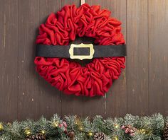 a christmas wreath hanging on the side of a door