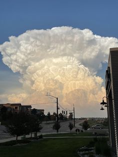 a large cloud is in the sky over a city