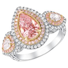 This three stone engagement ring is as rare as they come with an exotic 1.35 cts of light pink center stone and two colorless pears shapes as side stones surrounded by thousands of white and pink round diamond pave on the setting. GIA CERTIFIED Metal: 18k Gold Diamond Cut Center Stone: Pear Shape Diamond Cut Side Diamonds: Pear Shape, Round Brilliant Cut Diamond Cut: Very Good Total Diamond Carats: 2.55ct (Center Diamond 1.35ct) Diamond Clarity: VS1-VS2 Diamond Color: Fancy Light Pink, E-F Ring Pear Shaped Halo Engagement Ring, Pink Stone Engagement Rings, 18k Gold Engagement Ring, Pear Shaped Diamond Engagement Rings, Fancy Light, Expensive Jewelry Luxury, Cushion Cut Ring, Modern Engagement Rings, Three Stone Engagement