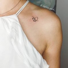 a woman with a small tattoo on her shoulder