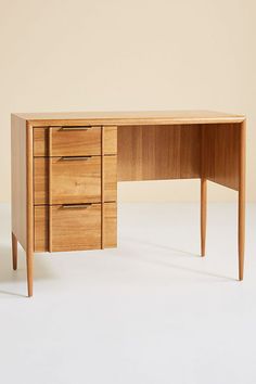 a wooden desk with three drawers on it