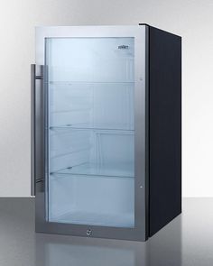 an empty refrigerator sitting on top of a counter next to a white wall and floor