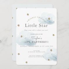 a baby shower card with gold stars on the front and blue watercolor clouds in the background